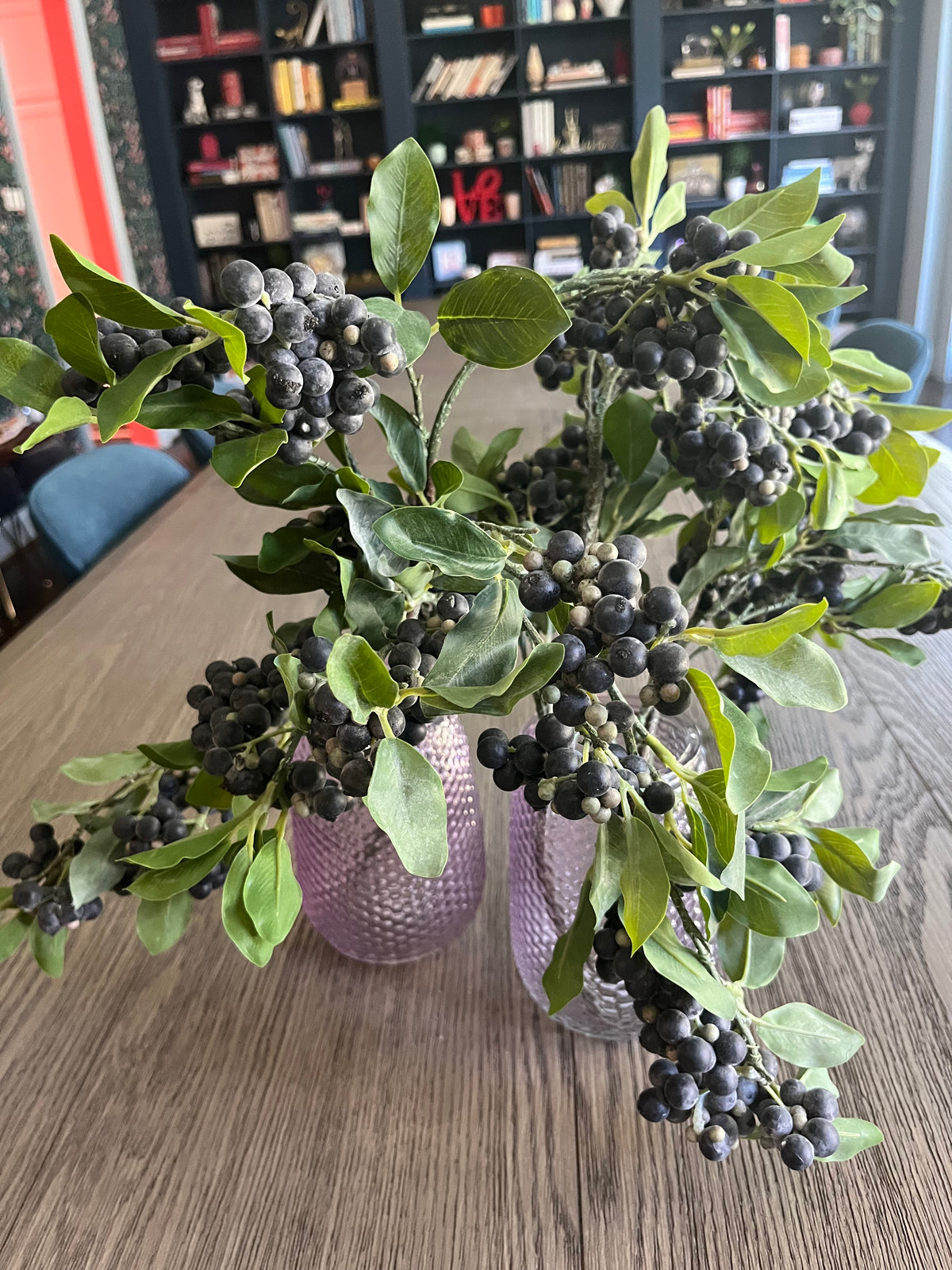 Pair of mauve glass vases with blueberry branches