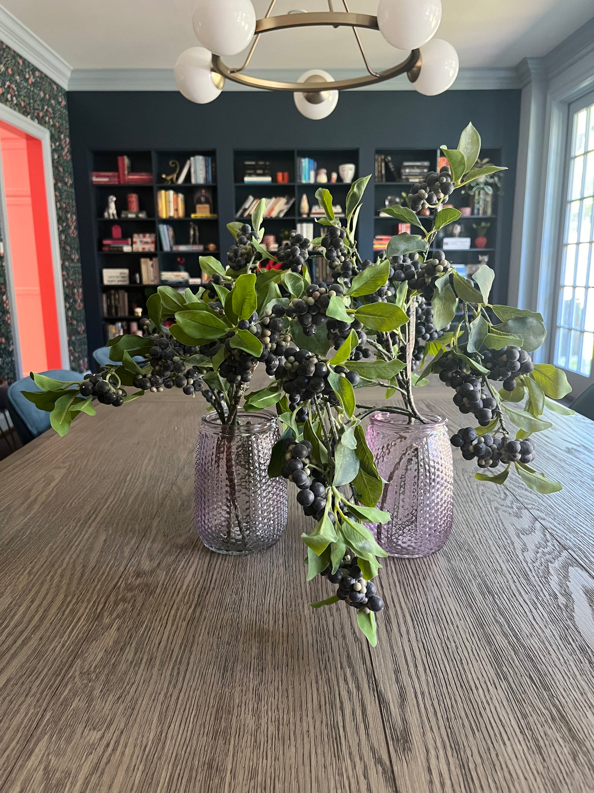 Pair of mauve glass vases with blueberry branches