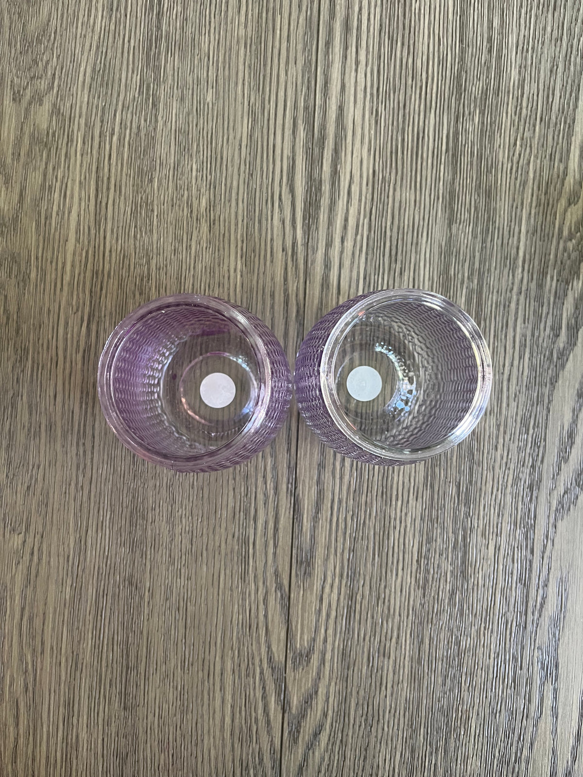 Pair of mauve glass vases with blueberry branches